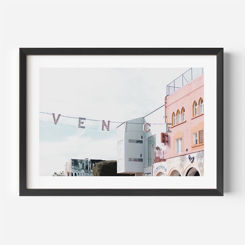 Framed photograph of a street scene with 'Venice' sign and buildings.