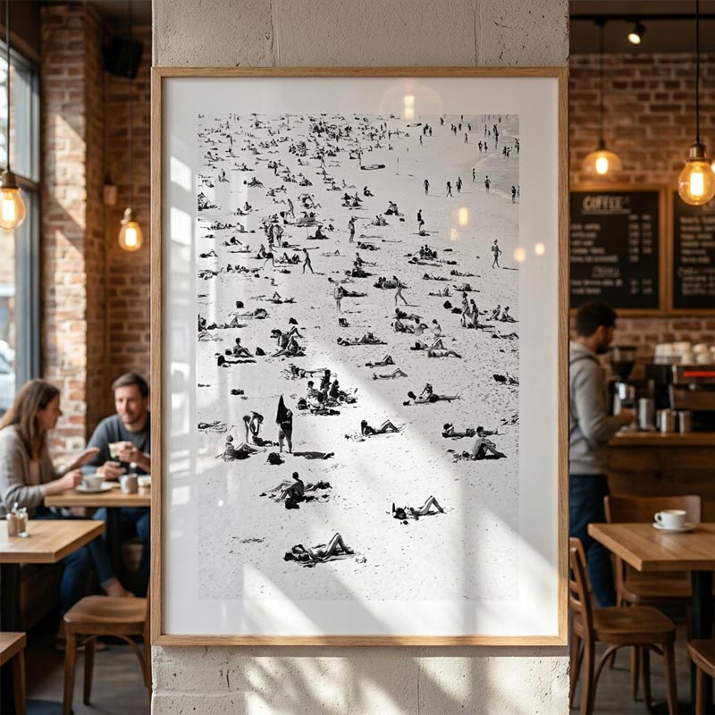 Framed artwork of a black and white illustration of people in a cafe setting