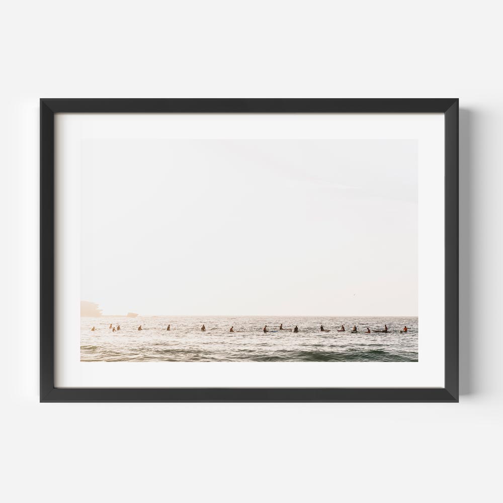 Framed beach artwork with surfers gliding on waves
