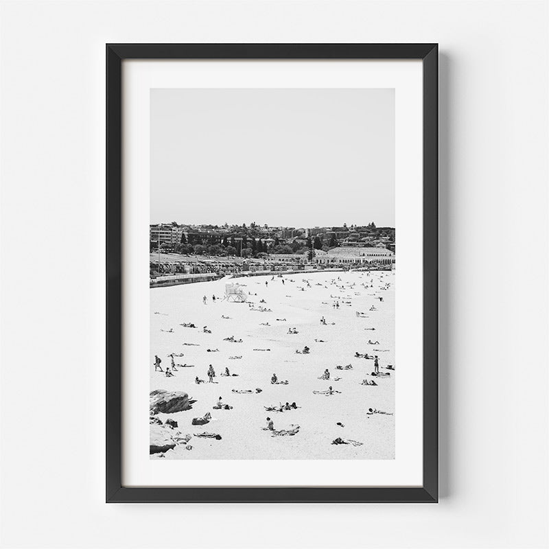 Framed black and white photograph of a beach scene with people.