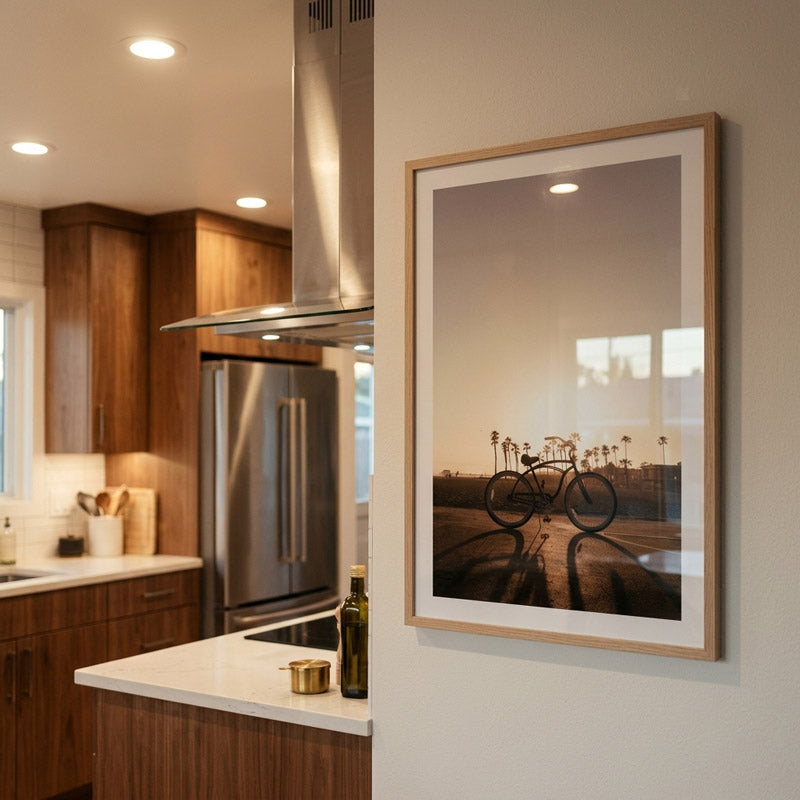 Modern kitchen with wooden cabinets, stainless steel appliances, and a framed picture on the wall.