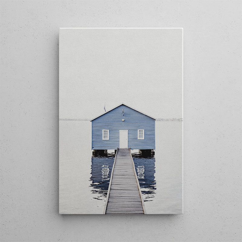 Blue boathouse with a wooden pier on a gray background