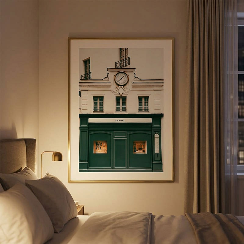 Wall art featuring a picturesque building with a clock, capturing the elegance of the Chanel building in Paris, France. It features in the bedroom.