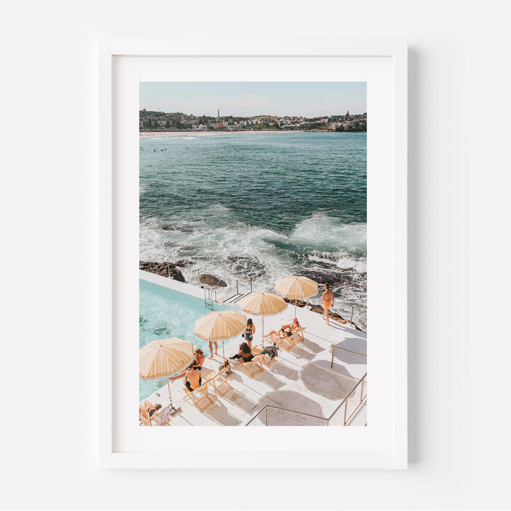 Bondi Icebergs coastal wall art featuring cheerful yellow umbrellas, turquoise ocean pool, and coastal living vibes.
