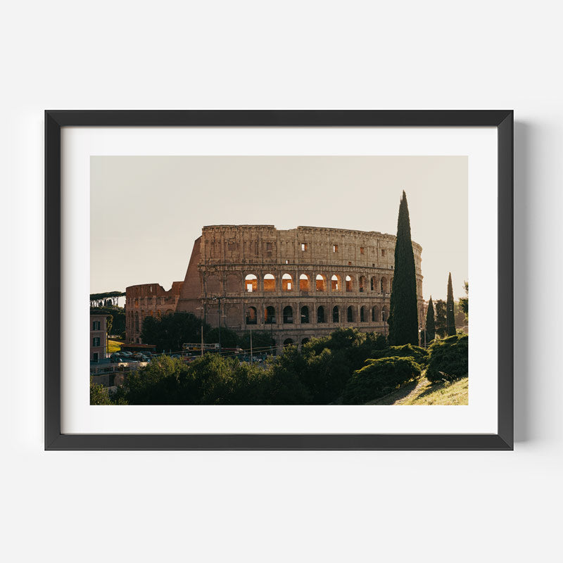 Framed wall art featuring a photograph of the Colosseum in Rome, shown in a black frame with a white mat against a light gray background.