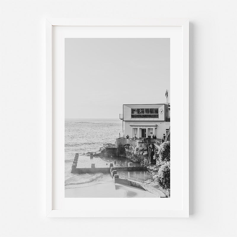 Framed black and white photograph of a coastal building with ocean view.