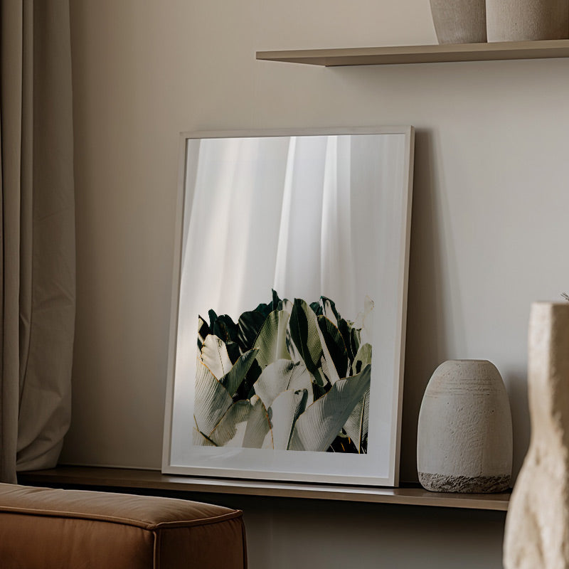 Framed artwork on a shelf with neutral decor