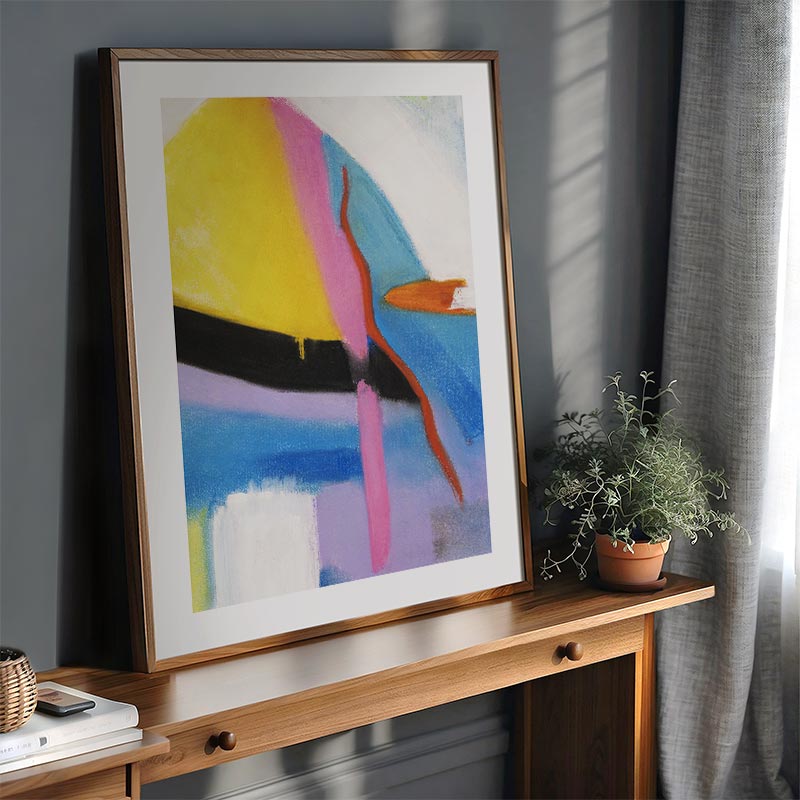 Framed abstract painting on a wooden shelf with a plant and books.