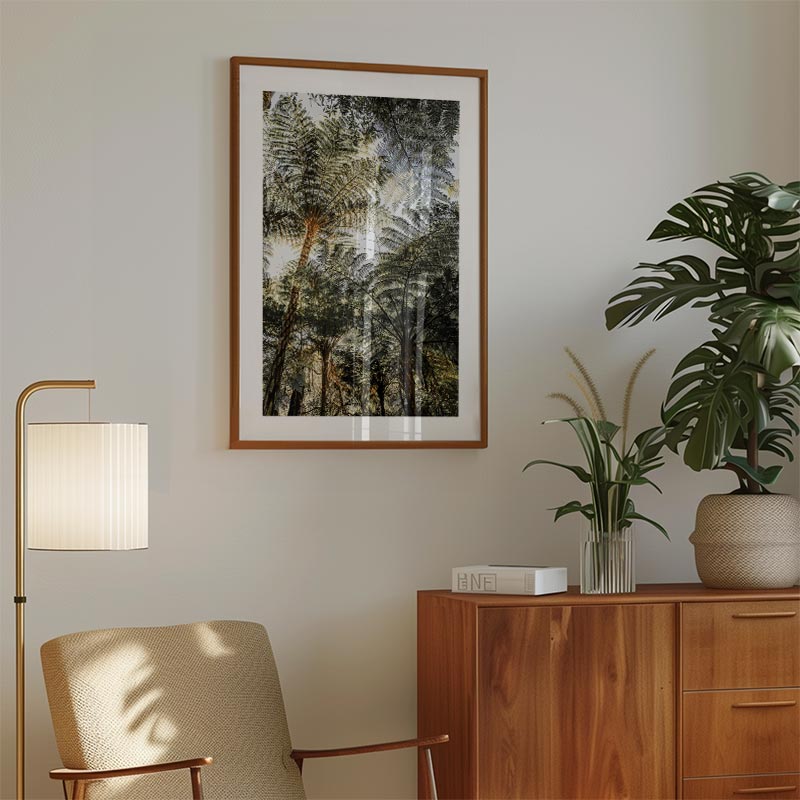 Living room with a framed nature print, lamp, chair, and wooden cabinet with plants.