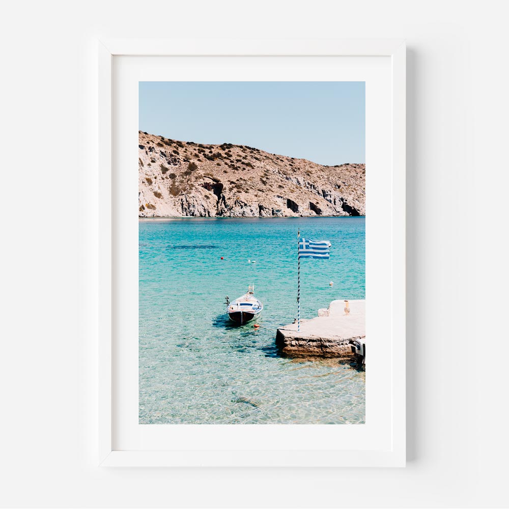Boat with Greek flag floating on turquoise waters in Firopotamos, Milos – coastal wall art print
