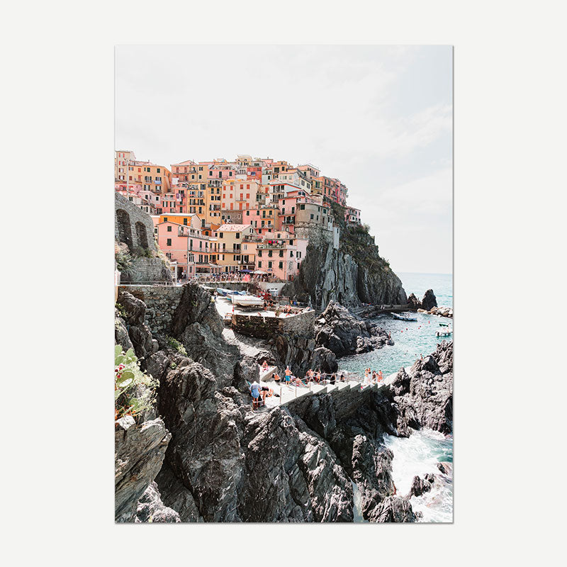 Colorful coastal town built on rocky cliffs with ocean view