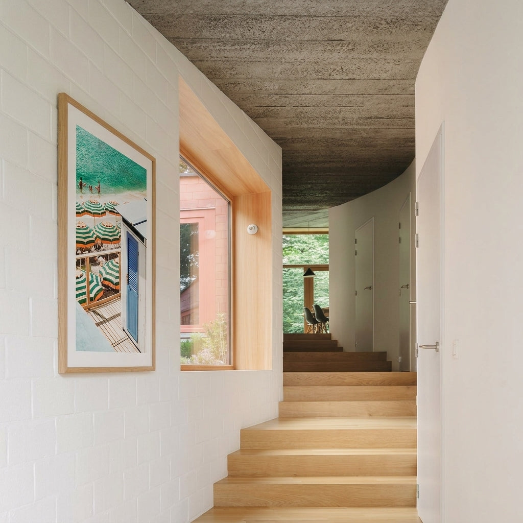 Staircase leading to an open-plan living area with a framed picture on the wall.