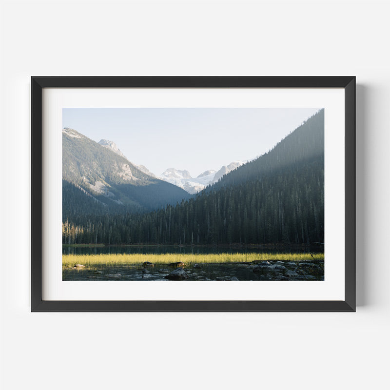 Framed photograph of a mountain landscape with a lake.