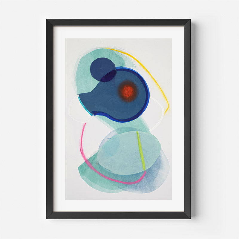 Abstract art print with blue, green, and red shapes in a black frame on a white wall.