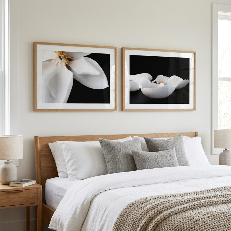 Bedroom with wooden headboard, white bedding, and framed floral artwork on the wall.