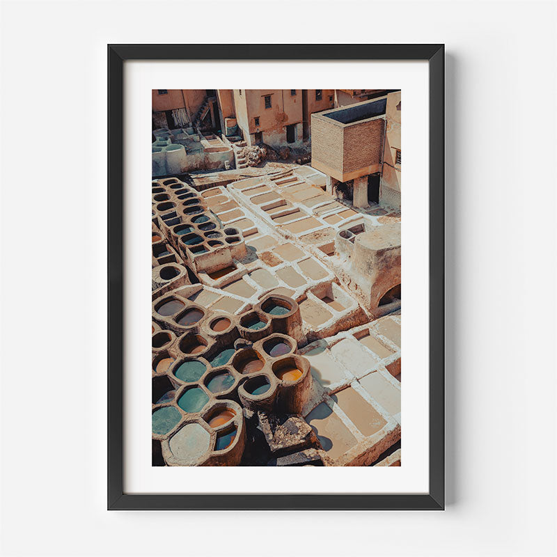 Framed photograph of tannery vats in Morocco on a white wall