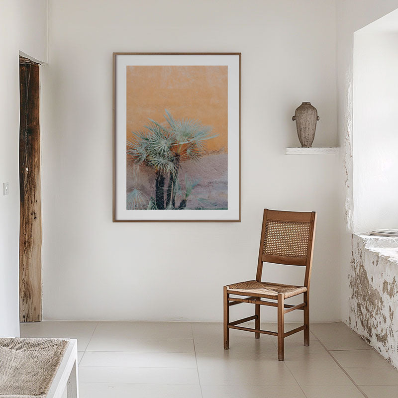 Wooden chair in a room with a framed abstract painting on the wall.