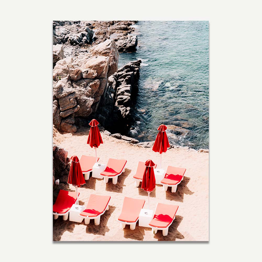 Red sundeck chairs and umbrellas in Mykonos