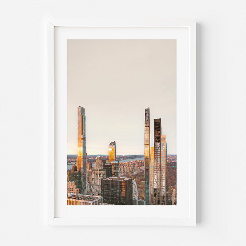 Framed cityscape print with tall buildings on a light background