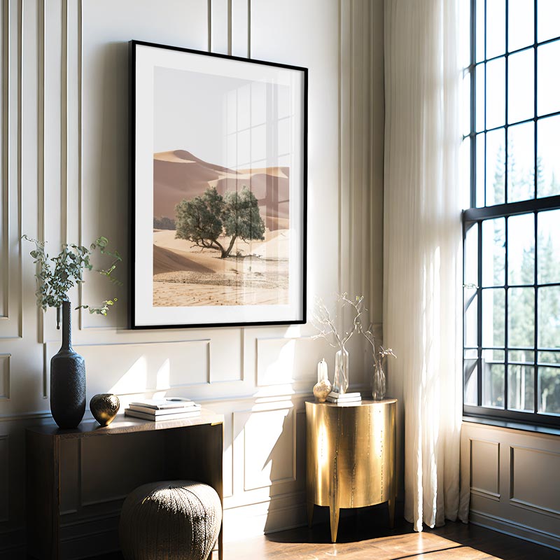 Modern interior with a framed landscape print, gold side table, and decorative items.