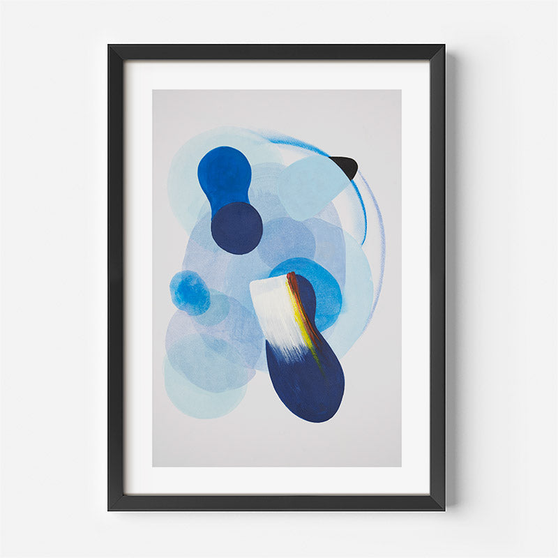 Framed abstract art print with blue and black shapes on a light gray background