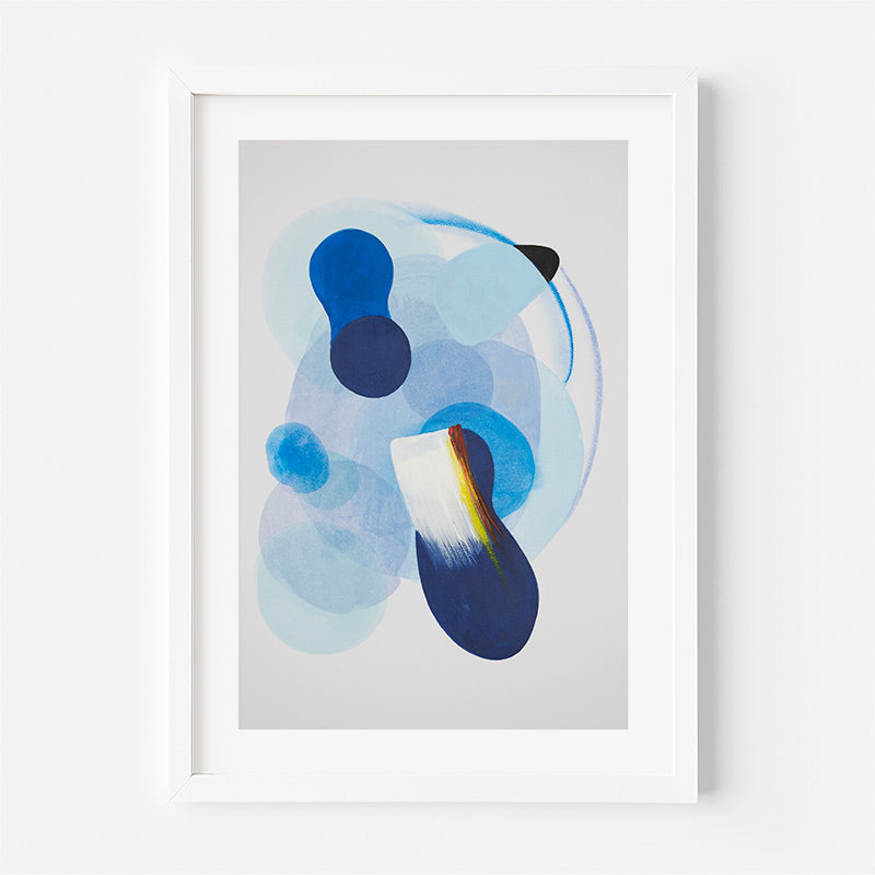Framed abstract art print with blue and black shapes on a light gray background