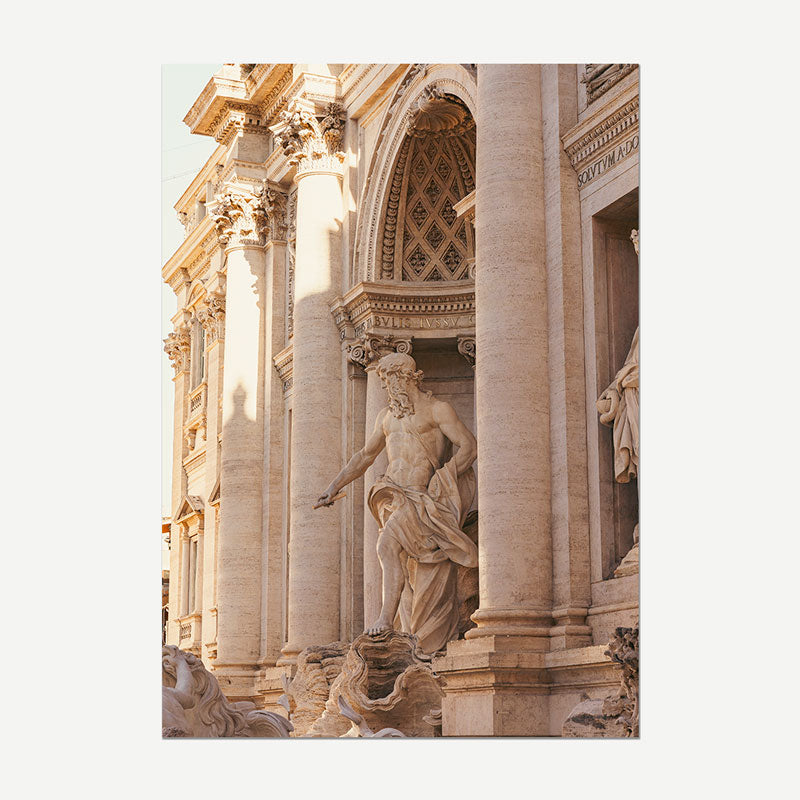 A vertical photographic print of the Trevi Fountain in Rome, showcasing the detailed beige stone columns and classical statue, presented as a mockup on a light gray background.