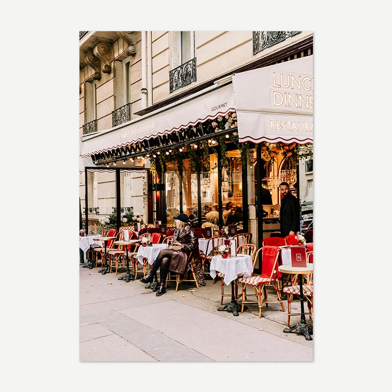 Outdoor cafe scene in front of a restaurant with tables and chairs.