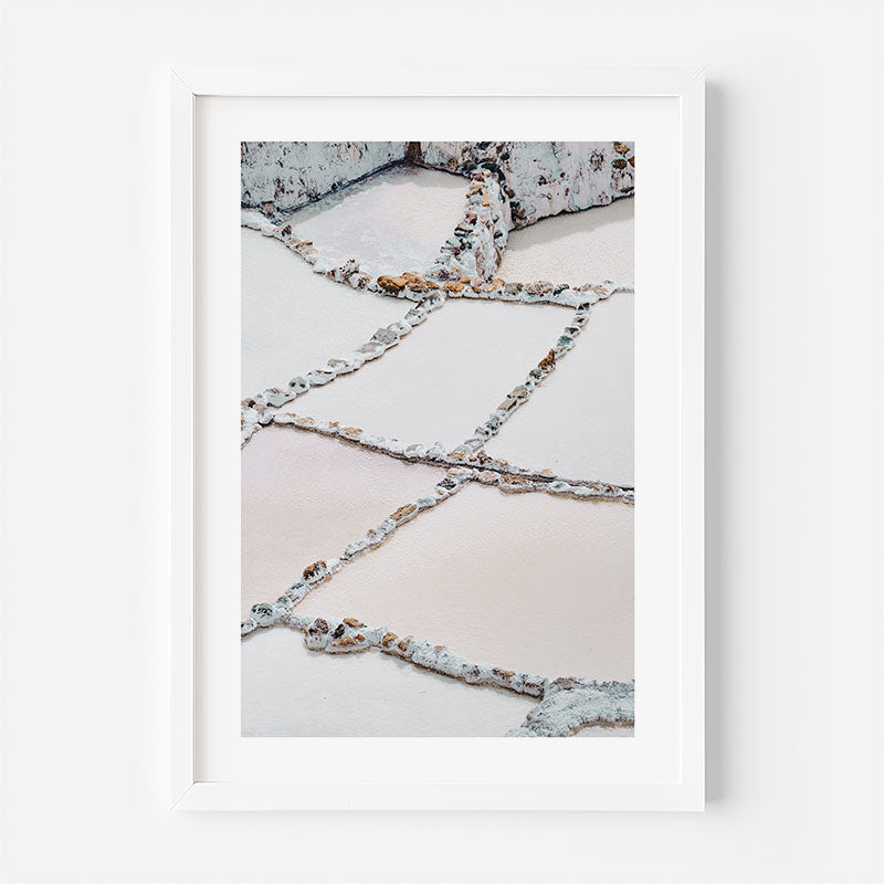 Framed photograph of a salt mine with geometric patterns on a white background