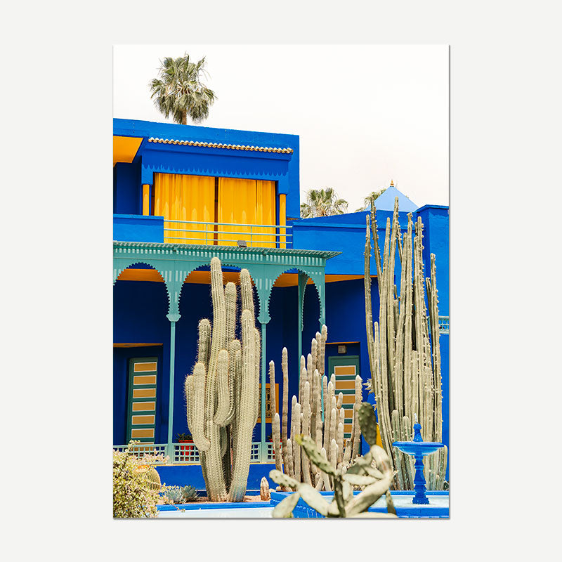 Colorful building with cacti in a desert setting