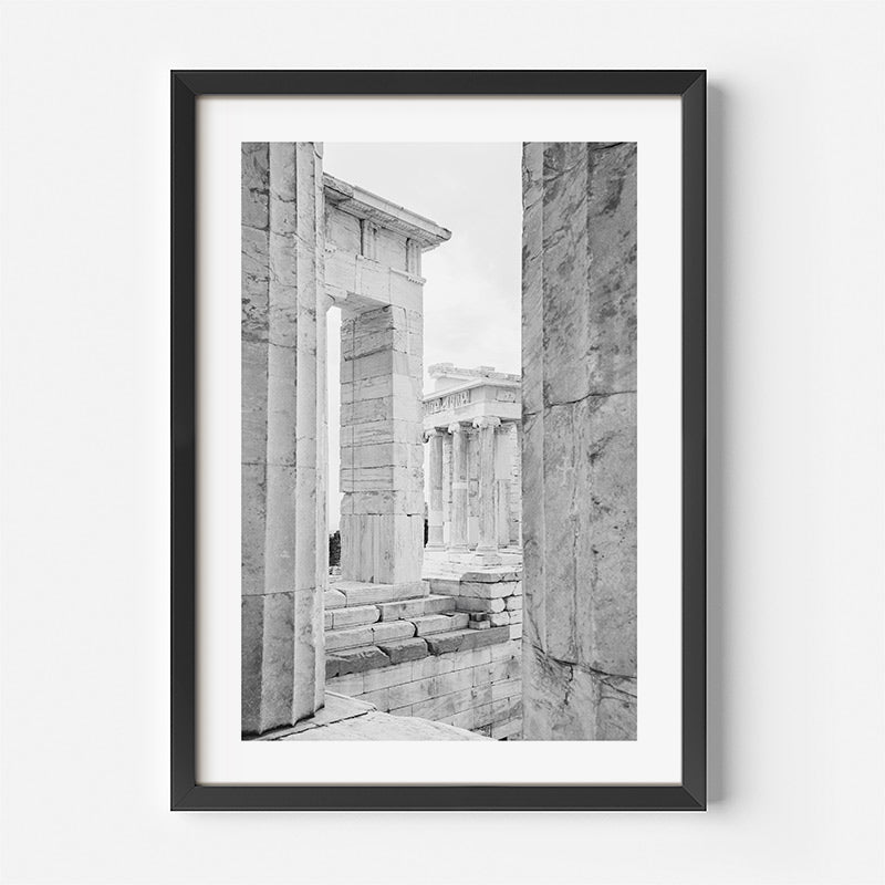 Framed black and white photograph of ancient stone architecture on a white wall