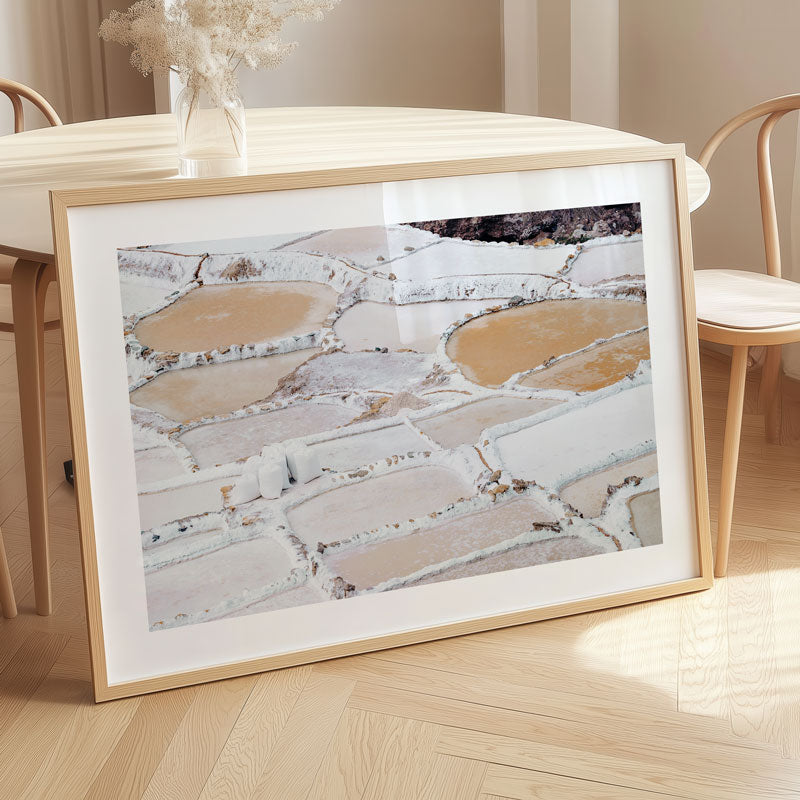 Framed photograph of terraced fields on a wooden table