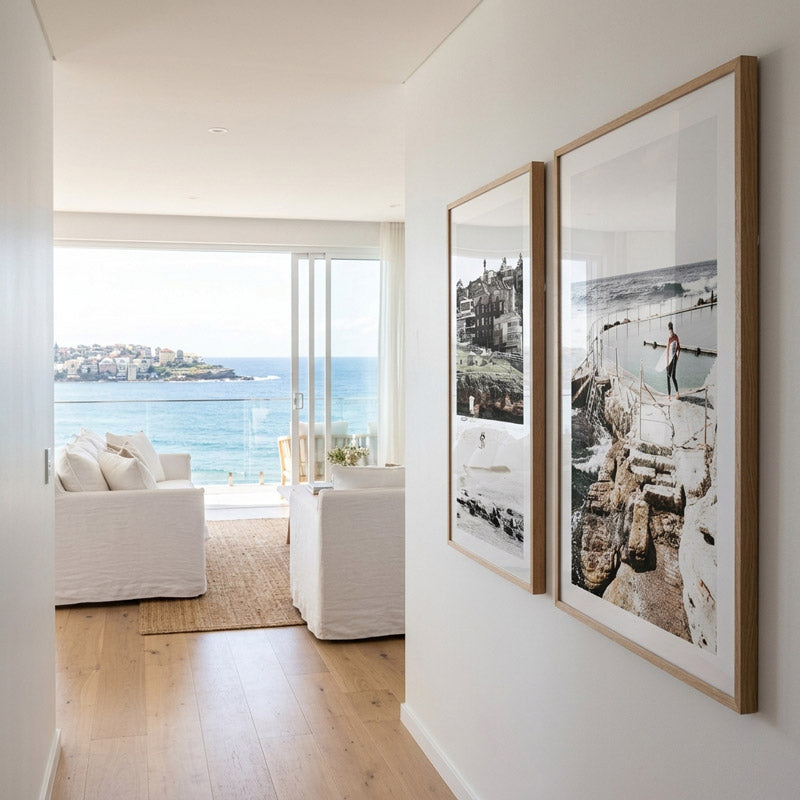 Modern living room with ocean view and framed artwork on the wall