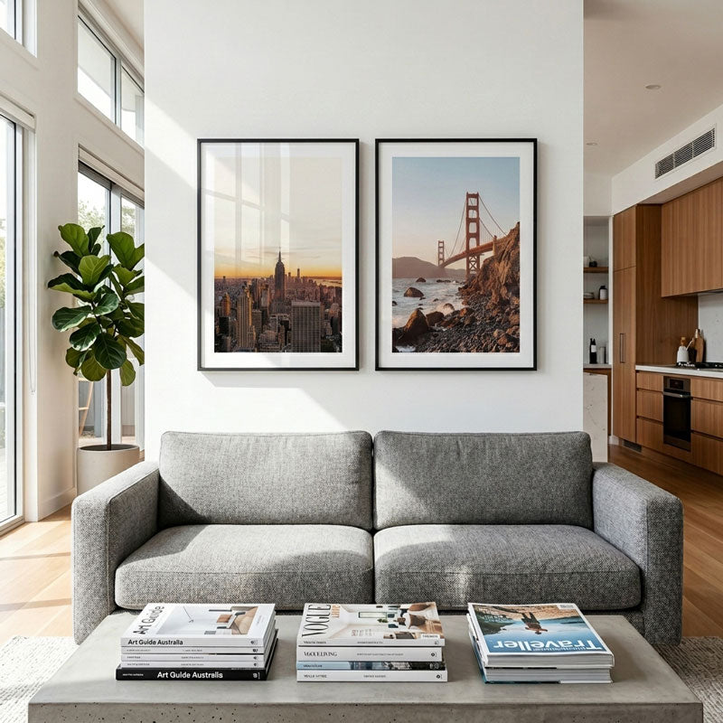 Modern living room with a gray sofa, coffee table, and wall art.