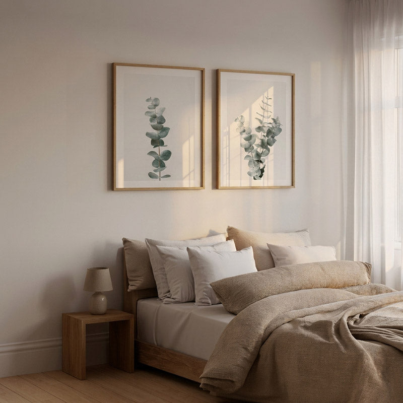 Neatly made bed with beige bedding and pillows in a bedroom setting.