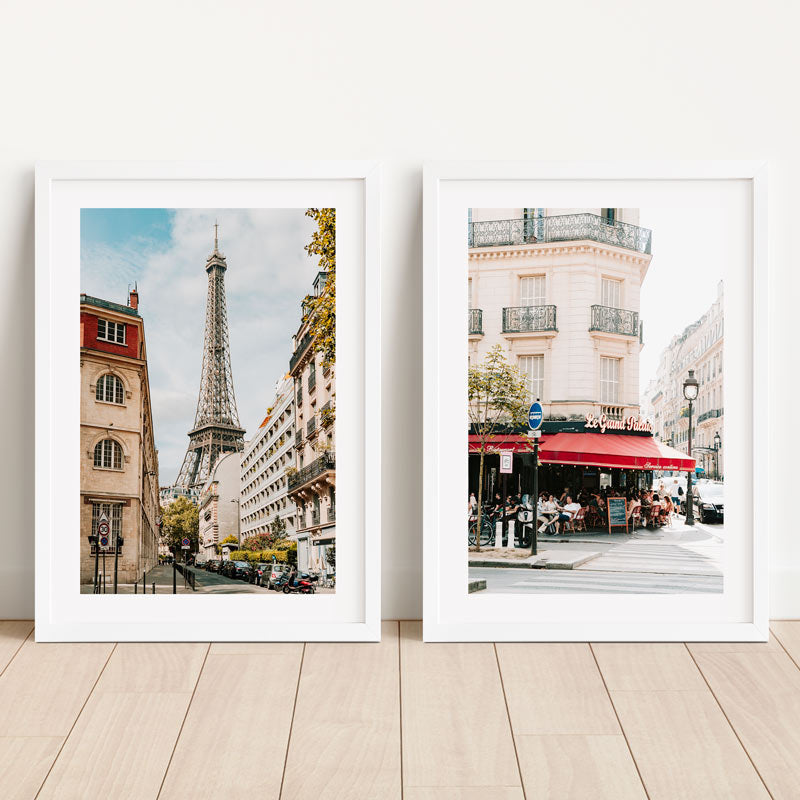 Two framed prints of Parisian scenes with the Eiffel Tower and a café.