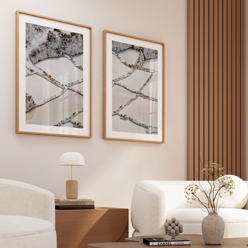 Modern living room with framed abstract art, a lamp, and a vase on a table.