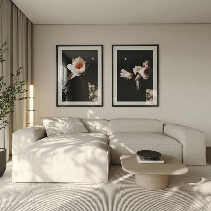 Modern living room with a white sectional sofa, coffee table, and floral wall art.