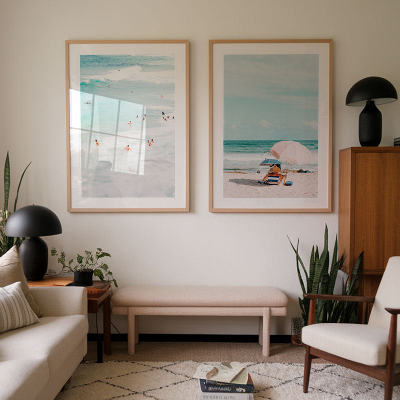 Living room with beach-themed wall art, furniture, and decor.