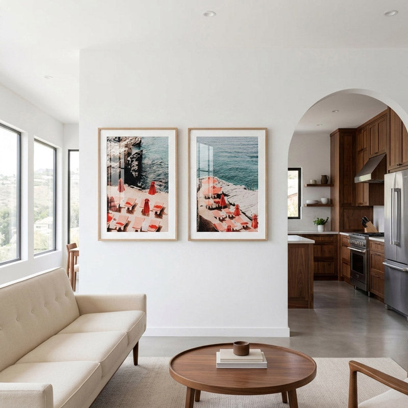 Modern living room with two framed artworks on the wall, a beige sofa, and a wooden coffee table.