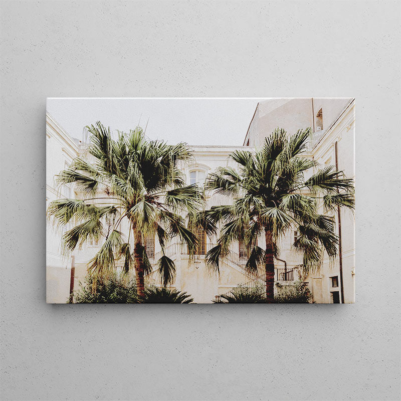 Canvas print of palm trees and a building on a gray wall