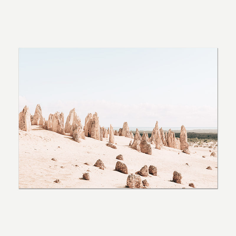 Desert landscape with tall rock formations under a clear sky