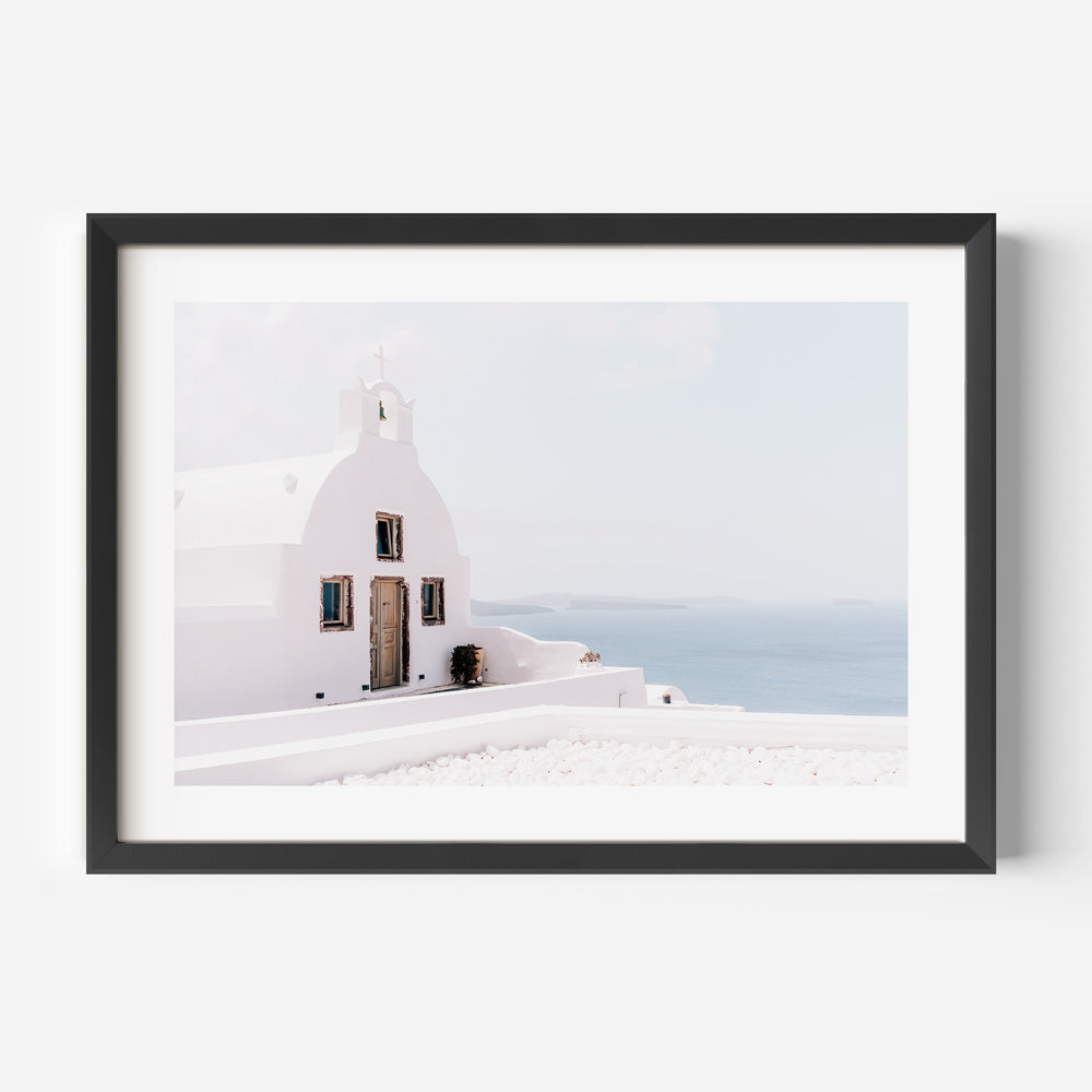 Peaceful chapel in Oia, Santorini, blending the beauty of the whitewashed architecture with the calm village atmosphere.