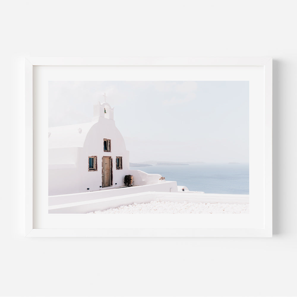 Whitewashed chapel in Oia, Santorini, capturing the peaceful essence of the village despite the crowds.