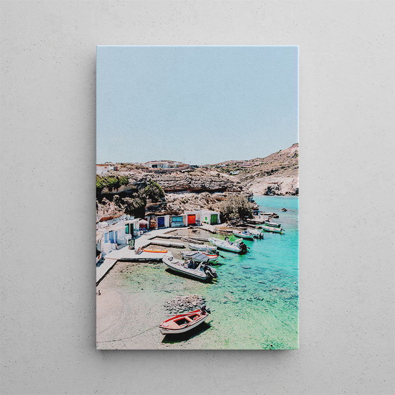 Canvas print of a coastal scene with boats and a clear blue sky.