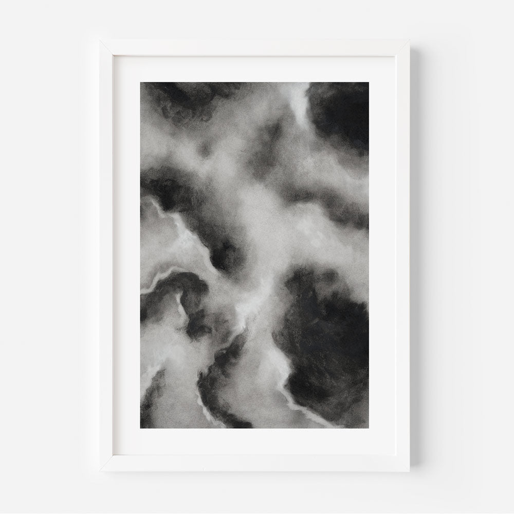 A framed art piece featuring abstract black and white cloud patterns.