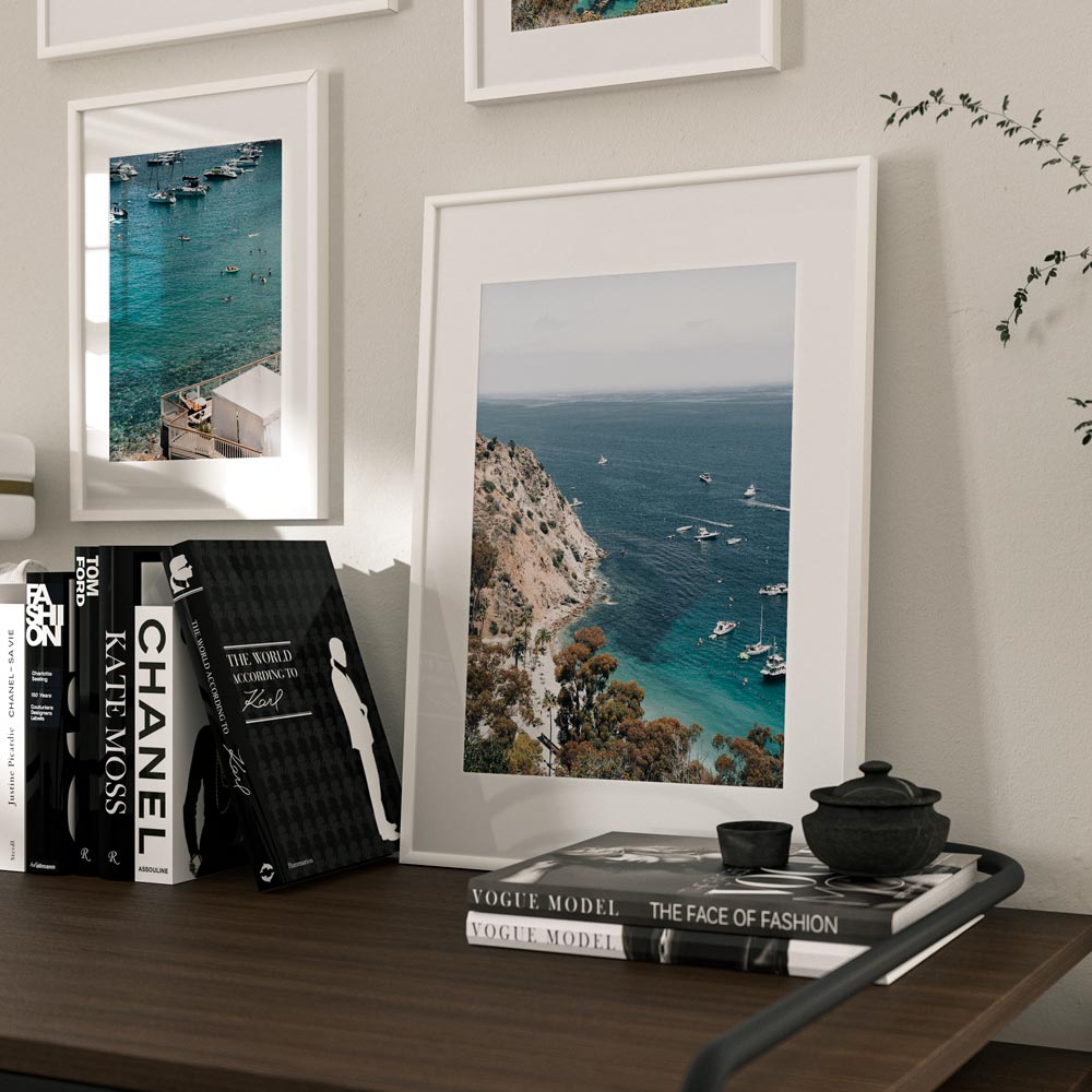 Framed coastal wall art showcasing Descanso Beach Club and Fourth of July celebration from above.