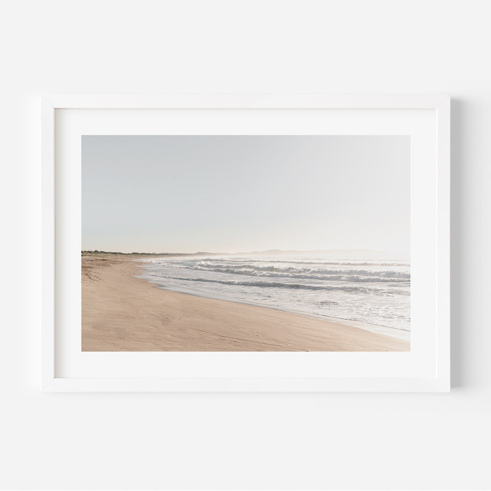 Unique coastal wall art featuring Wanda’s serene shoreline and green hills at sunrise in original photography