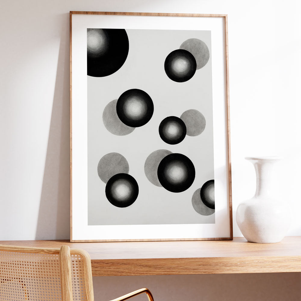 A framed Minimalist abstract wall art with black and white circular shapes and soft tonal contrast.