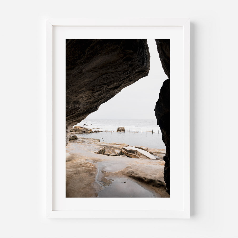 A framed photo of a beach and rocks - beach wall art decor from Oblongshop, capturing the beauty of MAHON POOL IN MAROUBRA.
